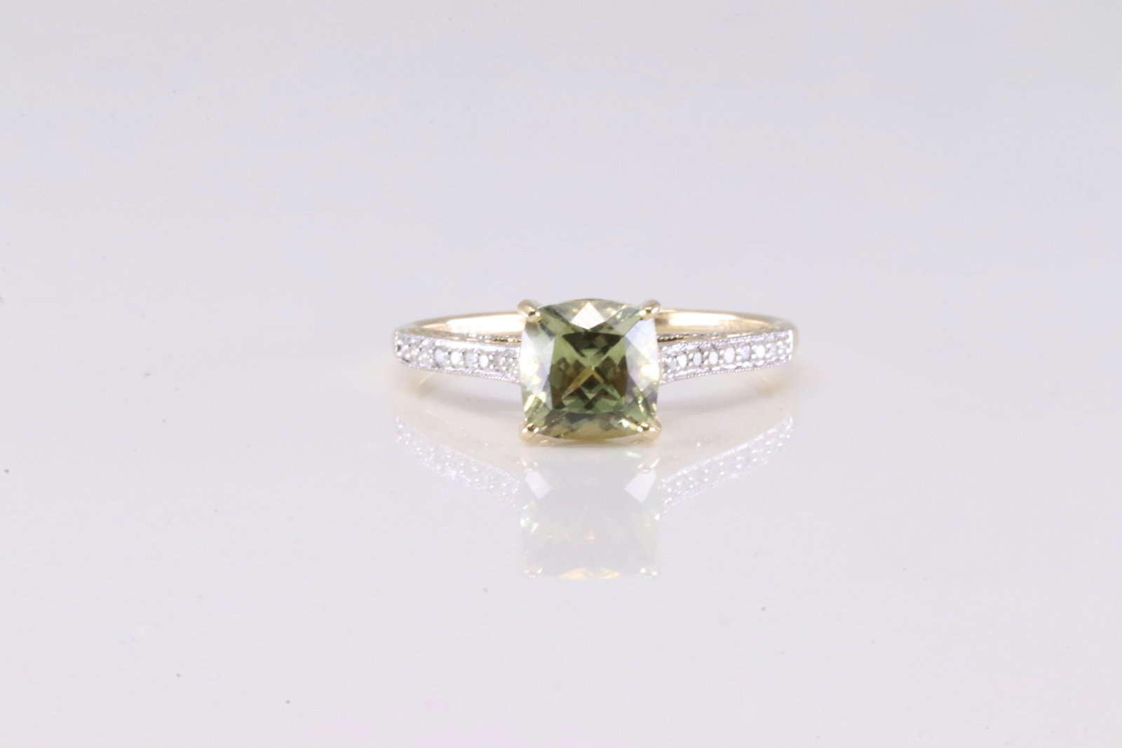 Peridot & Diamond Ring 14Kt.: Ladies 14Kt Yellow Gold Peridot & Diamond Ring. This Elegant Ring has Peridot Gemstone Surrender By Sparkling Diamonds. Ring size: 8.75. Total weight: 2.90 Grams.