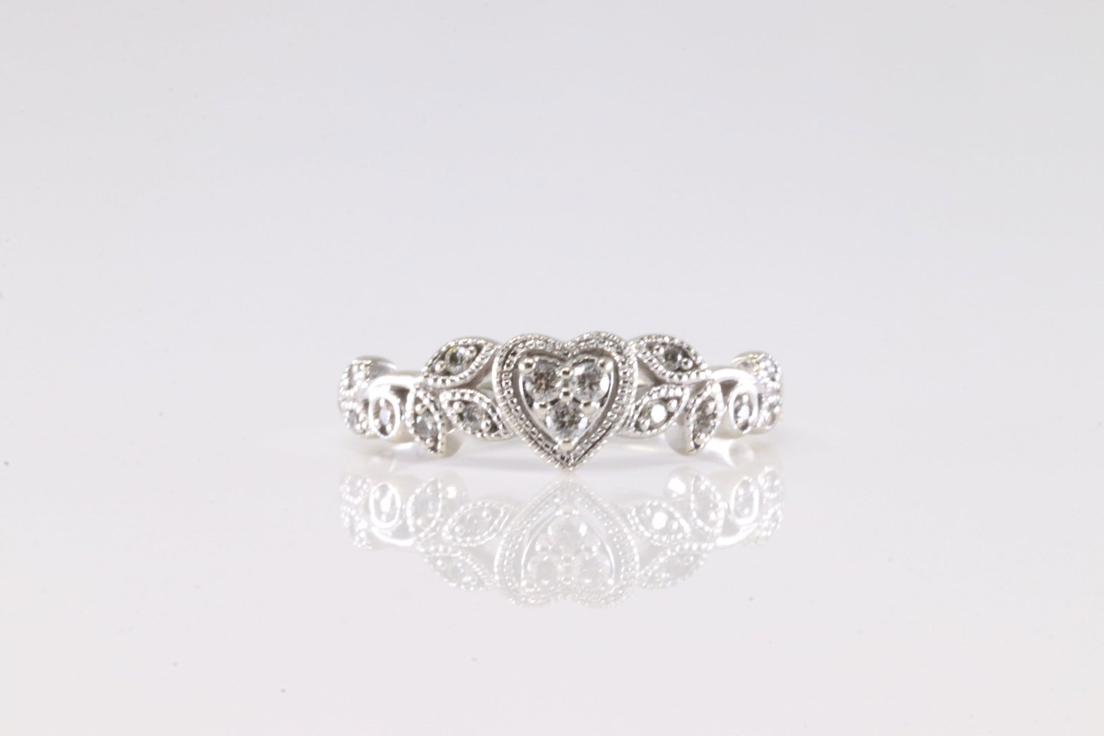 Diamond Heart Ring 10Kt.: Ladies 10Kt White Gold Diamond Heart Ring. This Charming Ring has Heart And Leaf Design with Sparkling Diamonds. 6.00. Total weight: 2.13 Grams.