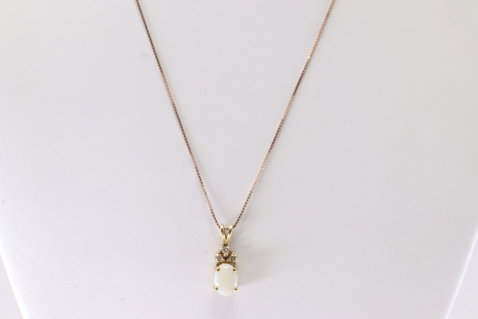Opal & Diamond Pendant / Necklace 10Kt.: 10Kt Yellow Gold Opal & Diamond Pendant / Necklace. This Charming Pendant has White Opal with Sparkling Diamonds and A 10K Rose Gold Necklace. Necklace length: 20.00" Total weight: 2.85 Grams.