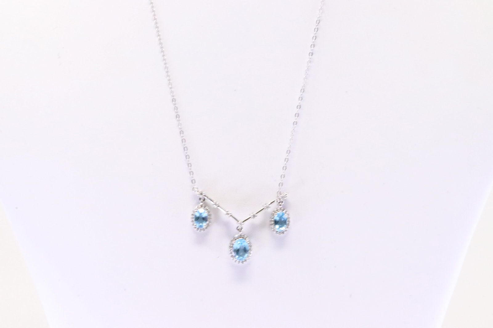 Blue Topaz & Diamond Necklace 10Kt.: Ladies 10Kt White Gold Blue Topaz & Diamond Necklace. Necklace has 3 Oval Blue Topaz Gems with round Diamonds. Diamonds weight: 0.25ctw. Necklace length: 16.00" Total weight: 3.20 Grams.