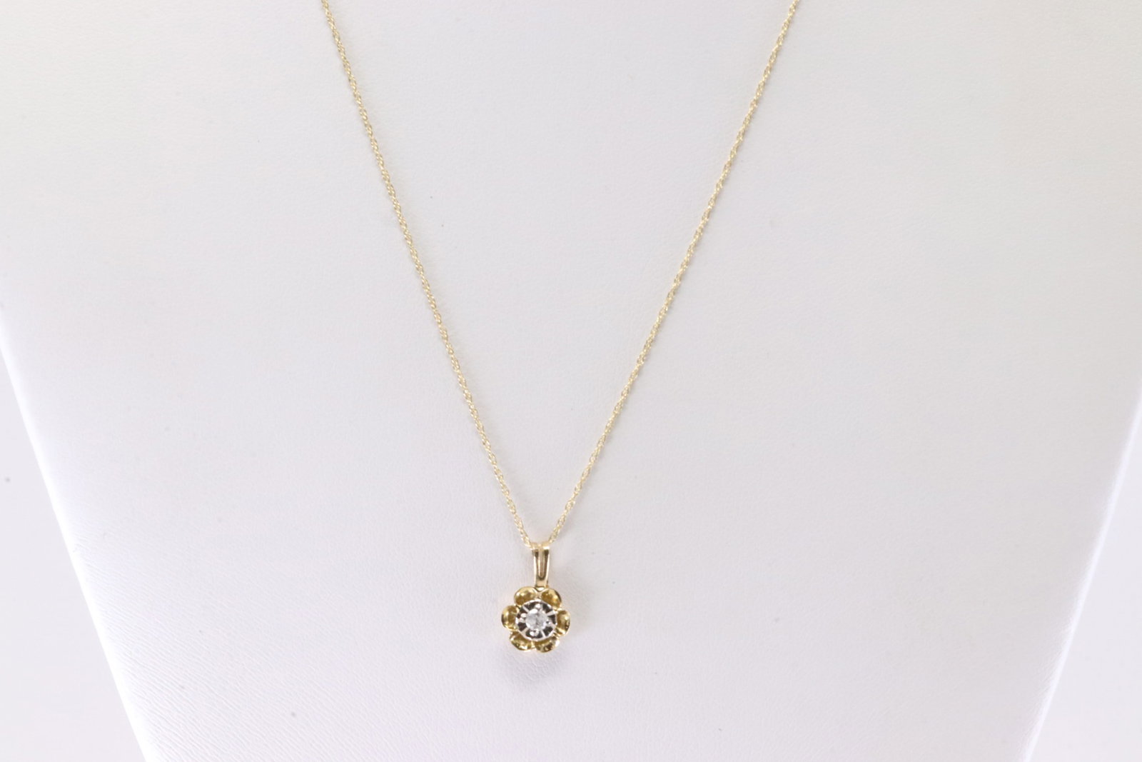Diamond Flower Pendant / Necklace 10Kt.: 10Kt Yellow Gold Diamond Flower Pendant / Necklace. This Charming Flower Pendant has Solitaire Diamond with A 10k Necklace. Necklace length: 20.00"