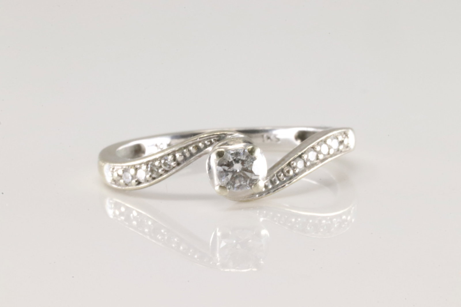 Promise Diamond Ring 10Kt.: Ladies 10Kt White Gold Promise Diamond ring. This beautiful ring has solitaire round diamond on the center surrender by 8 smaller to the sides. Diamonds weight approx: 0.50ctw. Ring size: 7.00.