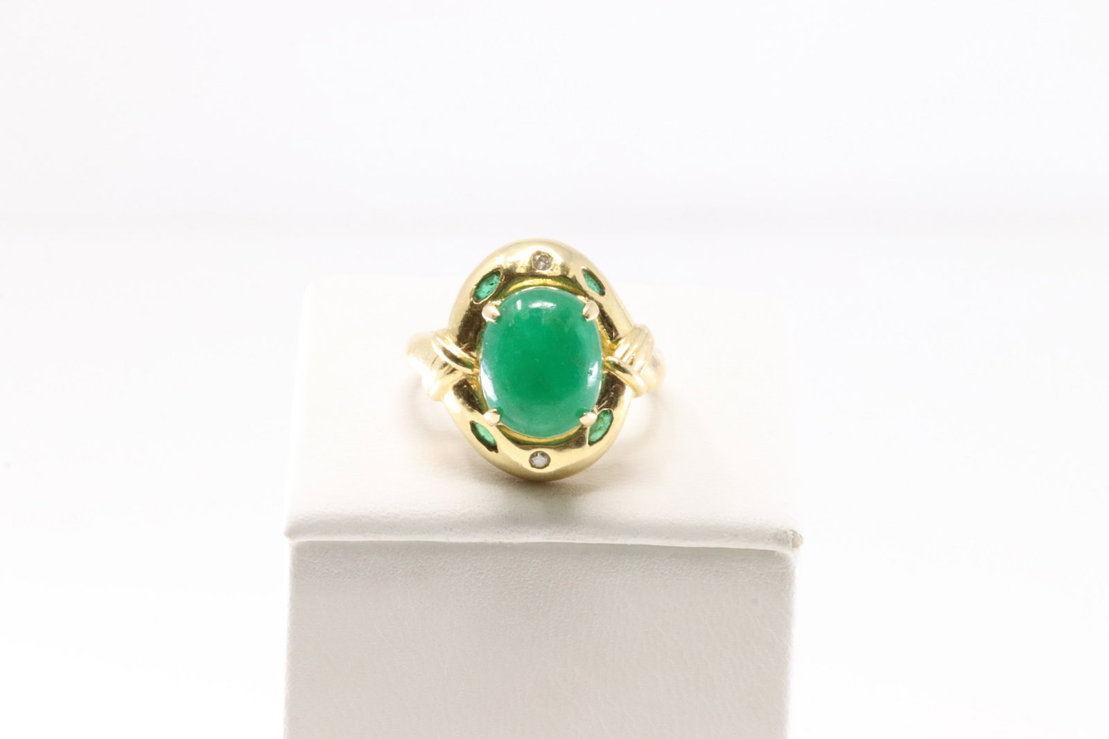 Cabochon Emerald & Diamond Ring 14Kt.: 14Kt Yellow Gold Emerald & Diamond Ring. Ring features a captivating green Emerald gemstone set in a luxurious gold band with 2 diamonds. The vibrant hue of the stone is beautifully complemented by th