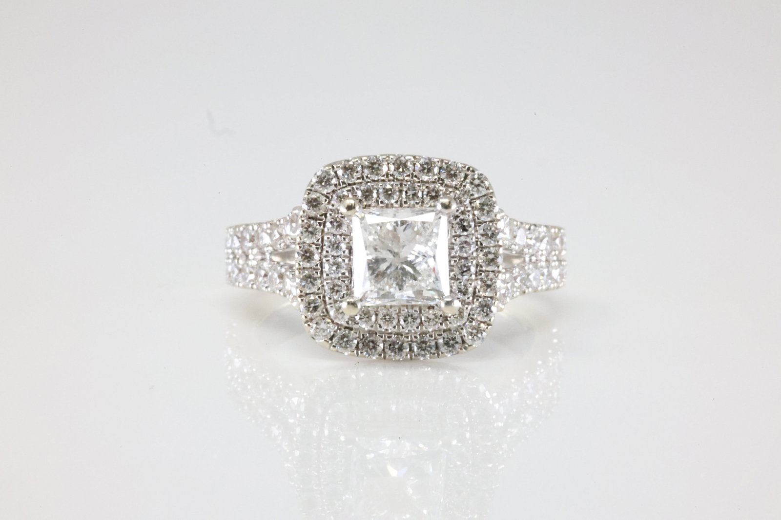 Ladies Engagment Diamond Ring 14Kt.: Ladies 14Kt White Gold Sapphire & Diamond Ring. This Charming Ring has 2 Sapphire Gemstones With 99 Round Sparkling Diamonds with a Princess Cut diamond set in the center. Diamond Weight Approx: