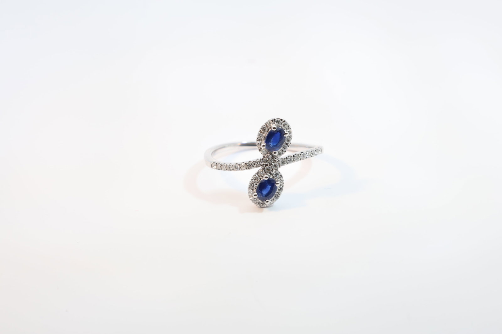 Sapphire & Diamond Ring 14Kt.: Ladies 14Kt White Gold Sapphire & Diamond Ring. Ring has 2 Oval Sapphire's with 42 round Diamonds. Diamonds weight: 0.21ct. Sapphire's weight: 0.047ct. Ring size: 6.50.