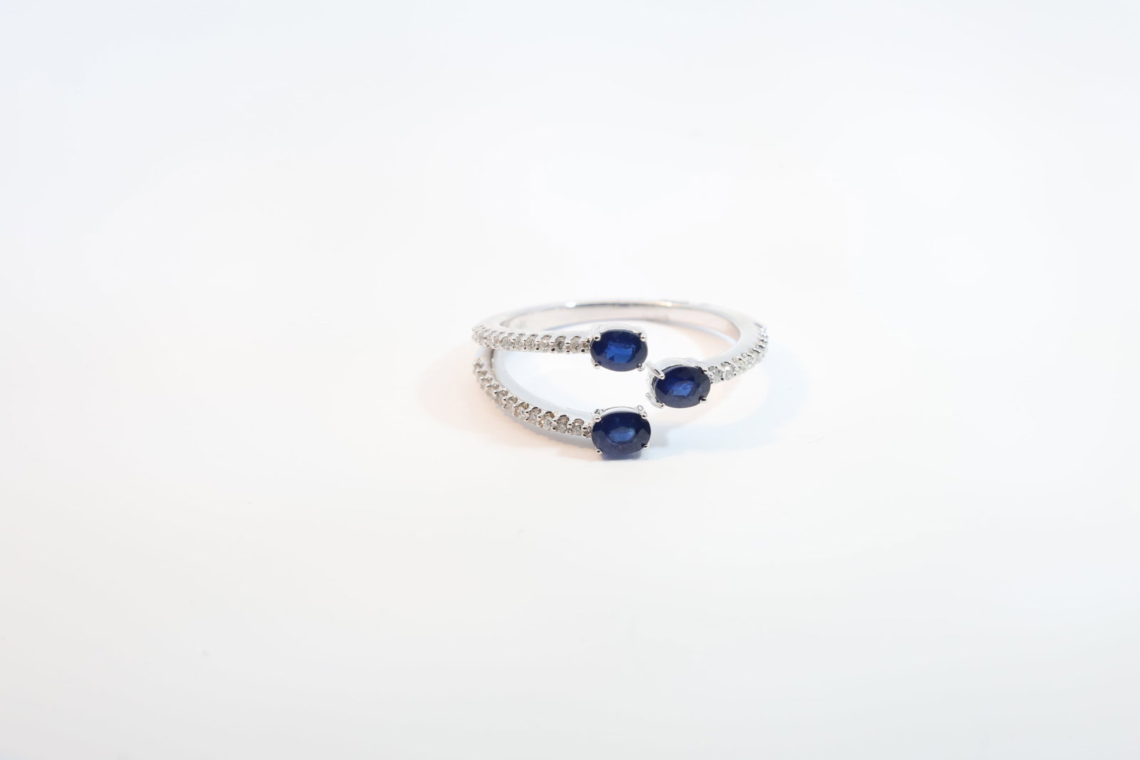 Sapphire & Diamond Ring 14Kt.: Ladies 14Kt White Gold Sapphire & Diamond Ring. Ring has 3 Oval Sapphire's Gems with 35 round Diamonds. Diamonds weight: 0.14ct. Sapphires's weight: 0.72ct. Ring size: 7.25. Total weight: 2.80 Grams.