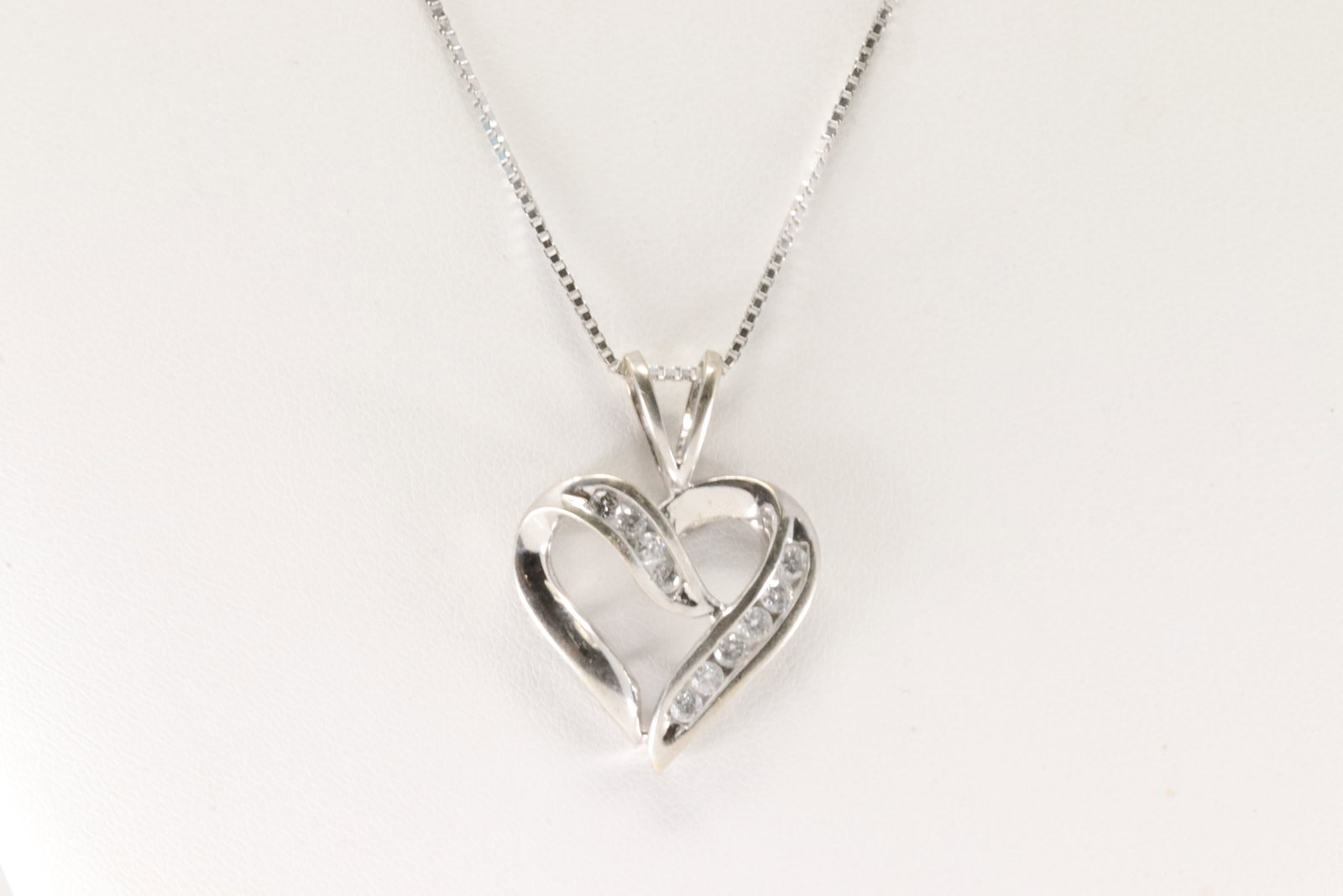 Diamond Heart Pendant / Necklace 10Kt.: 10Kt White Gold Diamond Heart Pendant / Necklace. This charming heart pendant has 10 round diamonds with a white 14 necklace. Diamonds weight approx: 0.30 ctw Necklace length: 18.00" Total weight: