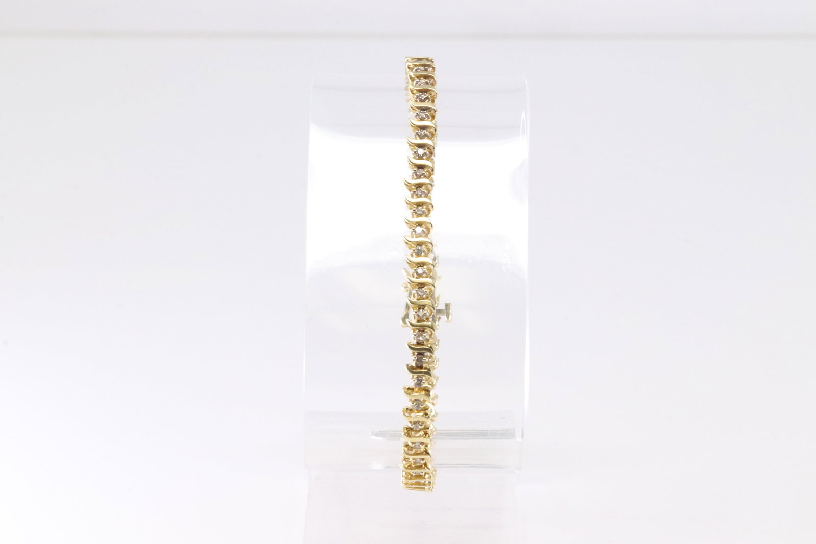 14KT Diamond Gold Bracelet: This exquisite gold bracelet features a series of intricately linked segments, each adorned with sparkling diamonds. Its elegant design makes it the perfect accessory for any sophisticated ensemble.