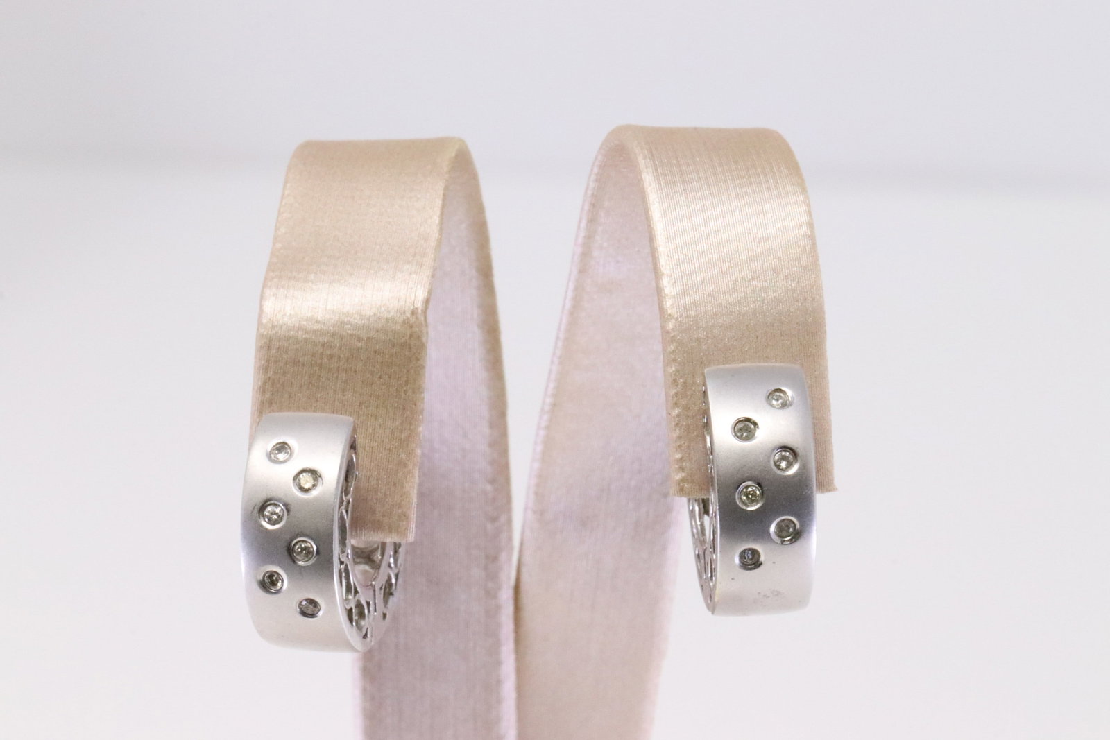14Kt White Gold Huggies Diamond Earring.: Ladies 14Kt White Gold Huggies Diamond Earring. Earring has 6 round Diamonds to each. Total weight: 7.47 Grams. AY-3E8FJ