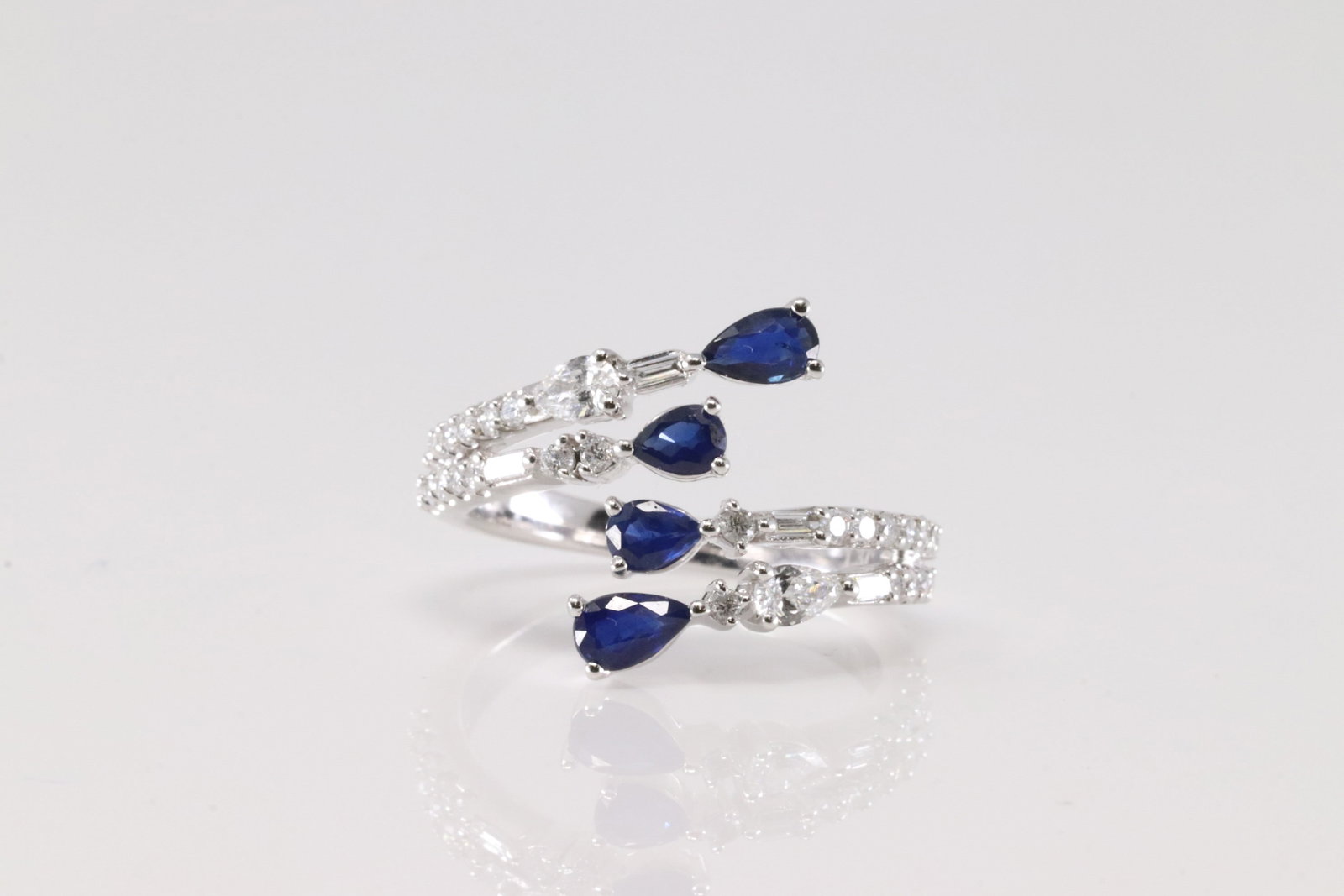 Sapphire & Diamond Ring 14kt.: Ladies 14kt White Gold Sapphire & Diamond Ring. This Ring 4 Oval Sapphire With 33 Round Sparkling Diamonds. Sapphire Weight: 0.78ctw. Diamond Weight: 0.59ctw. Ring Size: 6.50.