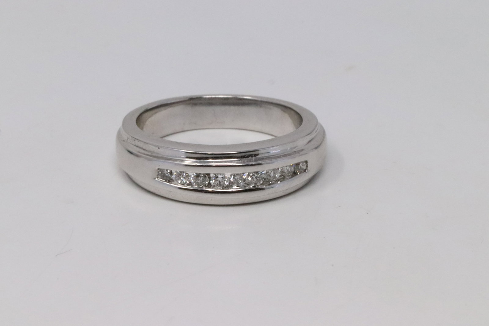 14Kt Men's Diamond Band Ring: A Men's 14kt White Gold Diamond ring. Ring has a total of 9 round brilliant diamonds. Diamonds weight 0.33ctw. Ring size: 7.00. Total weight: 7.70 grams. AP-93NF