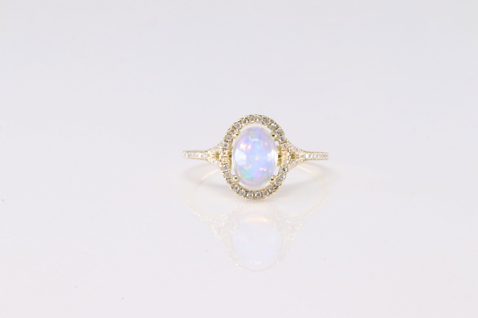 Opal & Diamond Ring 10Kt.: Ladies 10Kt Yellow Gold Opal & Diamond Ring. This Elegant Ring has Oval Opal Gemstone Surrounded With 58 Round Sparkling Diamonds. Diamond Approx Weight: 0.25 ctw. Ring Size: 7.00. Total Weight: 2.18