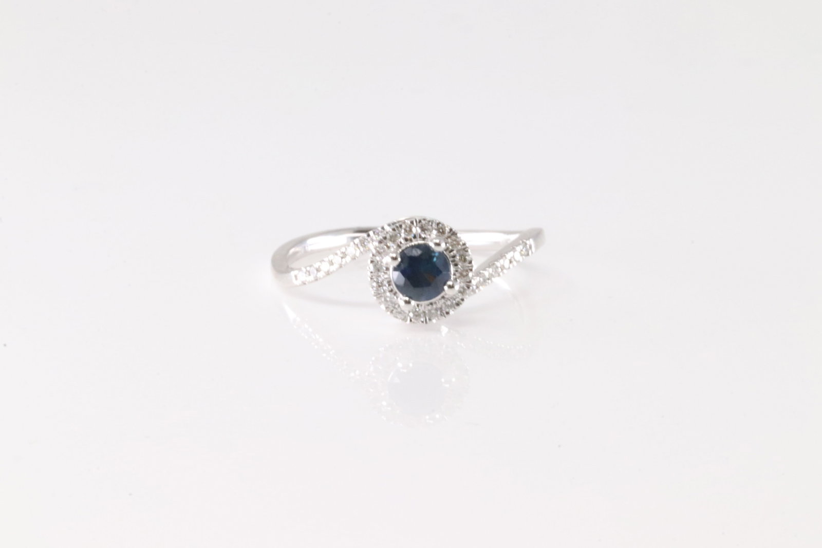 Sapphire & Diamond Ring 14Kt.: Ladies 14Kt White Gold Sapphire & Diamond Ring. This Elegant Ring has Blue Sapphire Surrender By 30 round Diamonds. Diamonds weight: 0.14ctw. Ring size: 7.00.