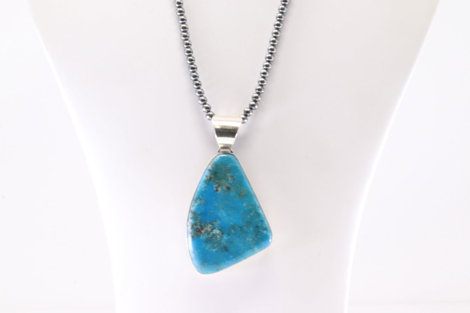 Native America Navajo Sterling Silver Turquoise Pendant By M. With Machine Made Sterling Silver: This is a Native America Navajo Sterling Silver Turquoise Pendant By M. With Machine Made Sterling Silver Pearl Beaded Necklace. Stamp M. Necklace Length: 18.00.