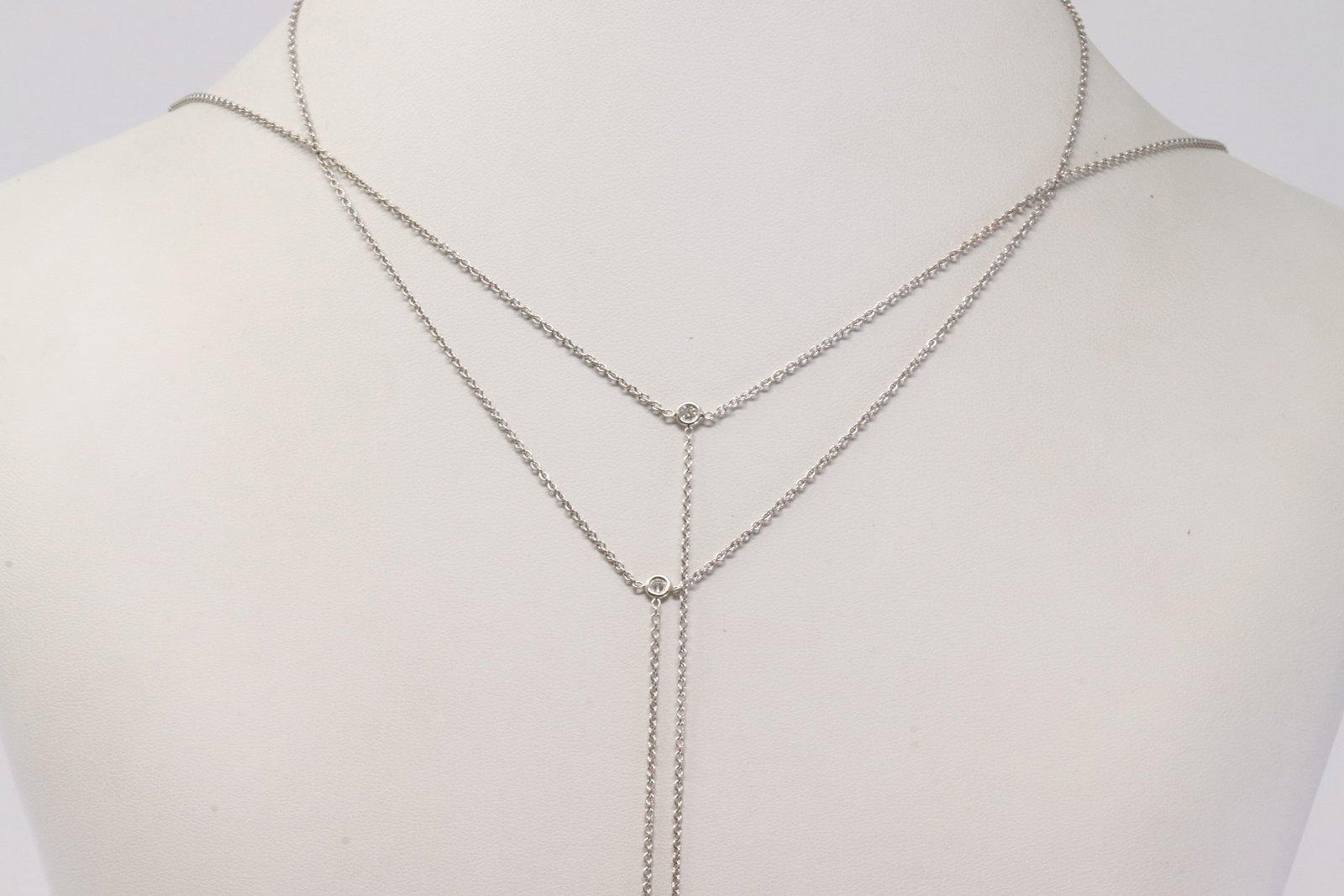 Diamond Double Strand Necklace 18Kt.: Ladies 18Kt White Gold Diamond Double Strand Necklace. This Elegant Necklace has Double Chain with 2 Sparkling Diamonds. Necklace length: 32.00" Total weight: 9.95 Grams.