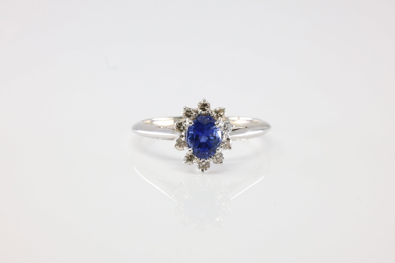 Sapphire & Diamond Ring 14Kt.: Ladies 14Kt White Gold Sapphire & Diamond Ring. This Ring has Beautiful Sapphire Gemstone In The Center Surrounded By 10 Round Sparkling Diamonds. Diamond Approx Weight: 0.50ctw. Ring Size: 7.50.