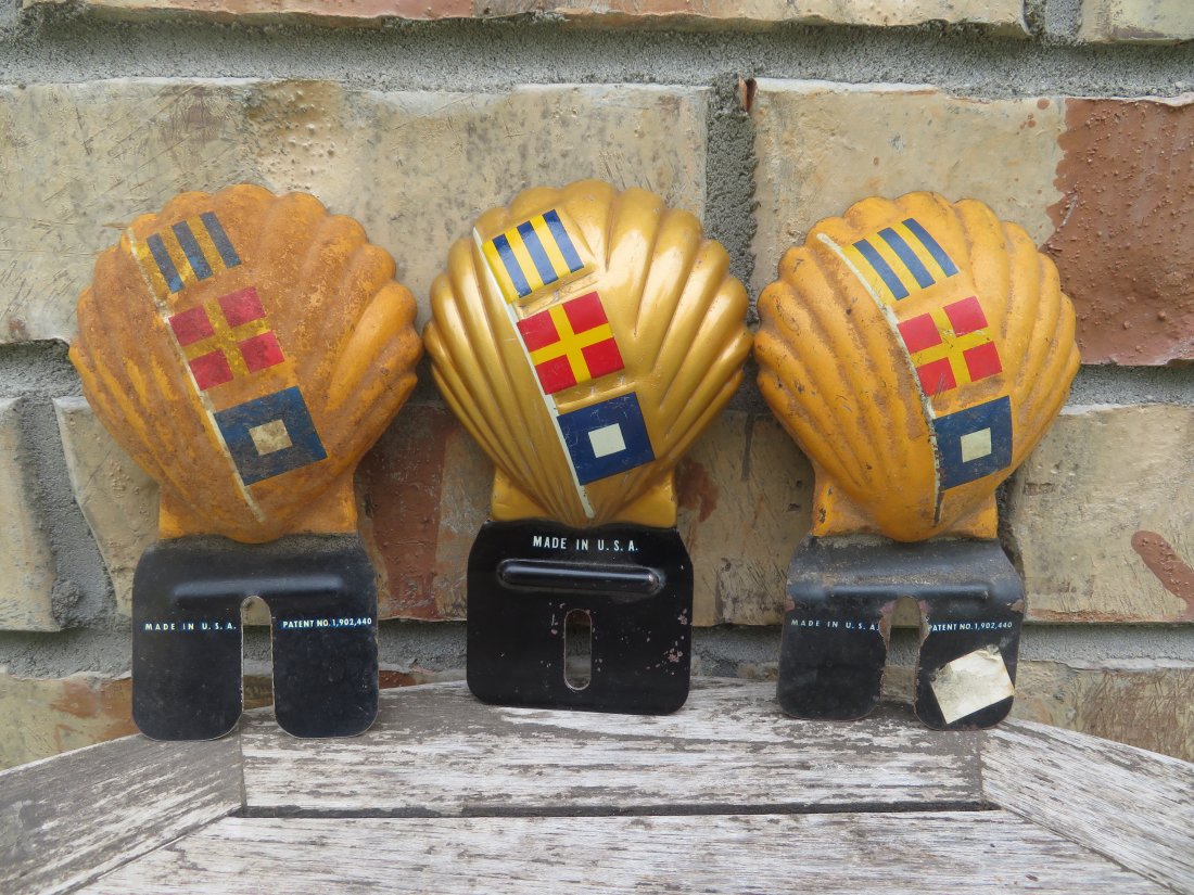 Set of 3 Vintage Shell License Plate Toppers: All appear to be made out of tin. Measures 5.5 by 3.5 inches. Comes in various conditions from very nice and clean to a little rusty, please check all pictures for conditional issues.