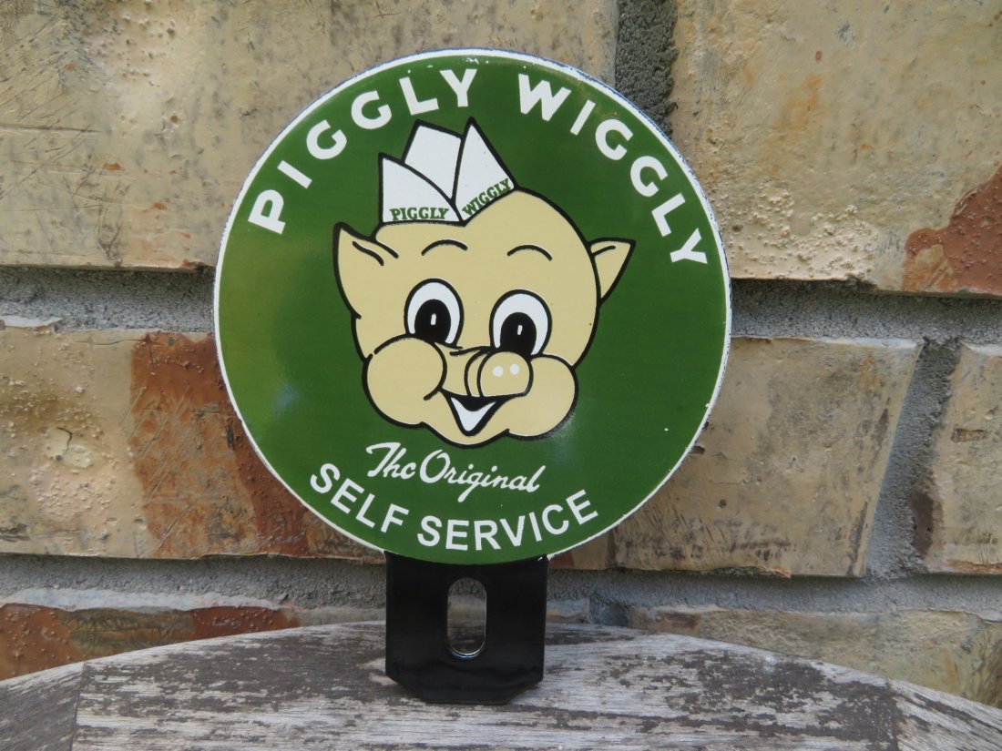 Vintage Porcelain Piggly Wiggly License Plate Topper: Measures approximately 5.5 by 4.5 inches.In mint condition, basically new old stock.