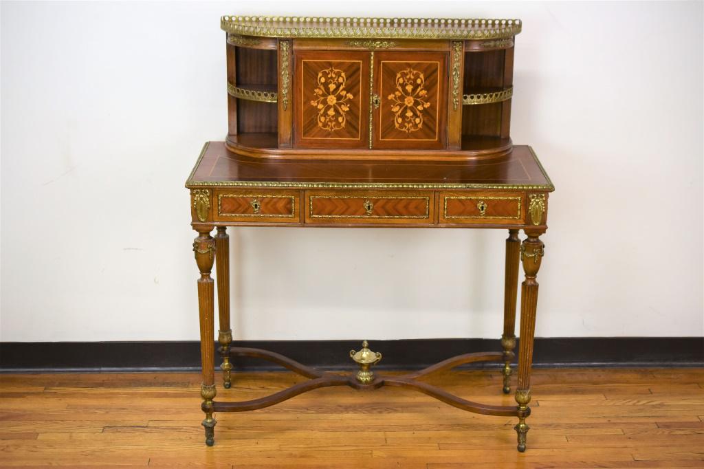 French Secretary Desk With Bronze Mounts: French desk or writing table, heavily inlaid and decorated with ornate bronze mounts. Measures approx. 37"l by 18"w by 44.5"h