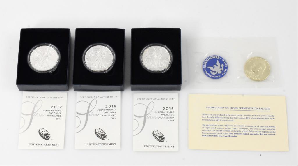 US Mint Silver Eagle Grouping: Includes 2015, 2017, and 2018 Silver eagles and a 1973 Eisenhower UNC. silver dolar