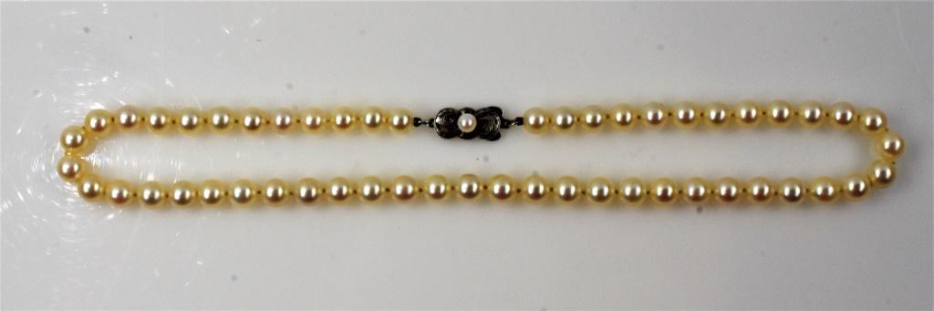 Mikimoto Pearl Necklace: A fine Mikimoto pearl necklace with sterling clasp and 7mm pearls.