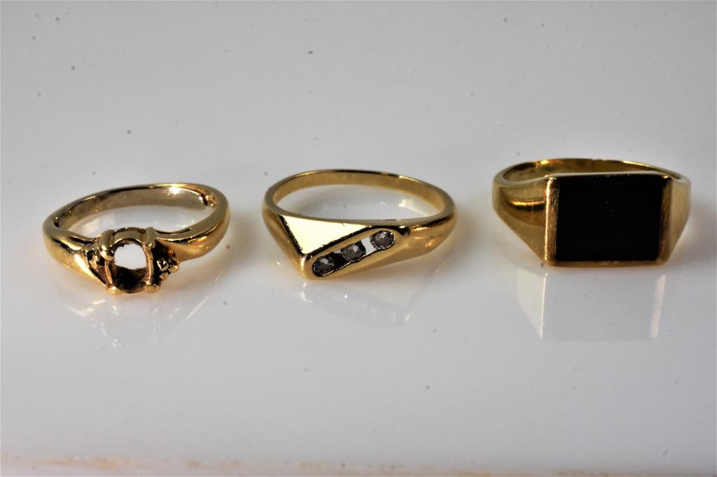 14K Gold Ring Grouping: Grouping includes (3) rings; (1) 14K yellow gold ring with (3) channel set diamonds, (1) 14K yellow gold and black onyx ring, and (1) 14K yellow gold setting with no stones. Also includes a 10K yellow