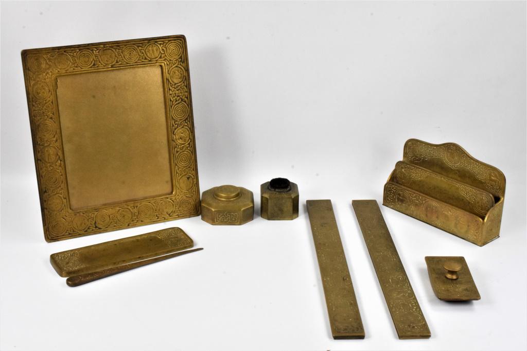 Tiffany Studios Gilt Bronze Desk Set: Amazing (9) piece Tiffany and Co. zodiac pattern gilt bronze desk set, including: (1) picture frame measuring approx. 12.25"l by 14.25"h (1) inkwell (1) rocker blotter (1) letter opener (1) letter hol