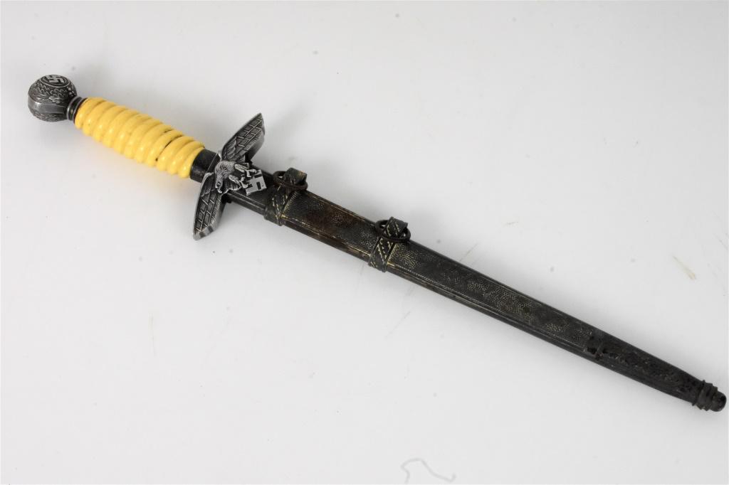 2nd Model Luftwaffe WWII German Dagger & Scabbard: 2nd Model Luftwaffe Dagger with Off-White or Cream Colored Grip. No visible RZM or Blade Markings. Cross Guard Eagle shows Good Relief with Bright High Points and excellent detail to the Feathering an
