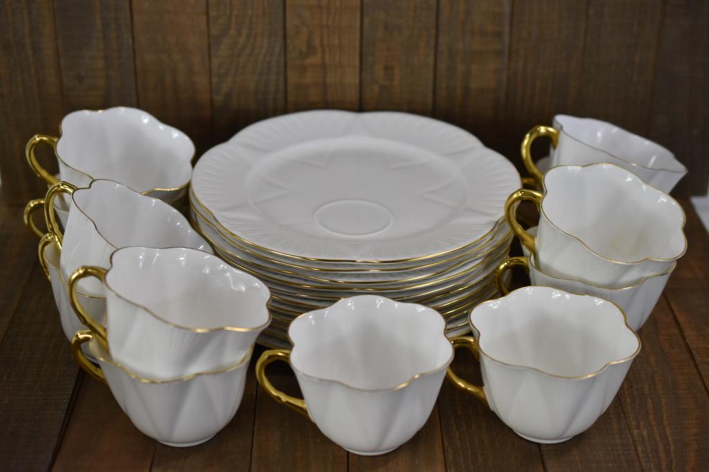 Shelley England Cup and Plate Set for 11: Set includes (11) Shelley Englanc dessert plates measuring approx. 8"l and (11) Shelley England ruffle tea cups. Set also includes (1) extra tea cup. Marked "Fine Bone China, Shelley England" on base.