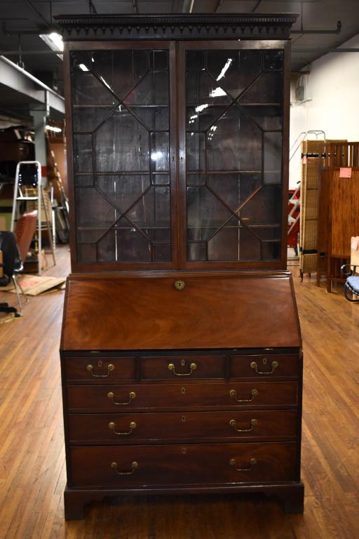 English Chippendale Mahogany Secretary Desk: An English Mahogany two part desk, top with glazed doors; interior on desk has hidden sliding door. (2) keys. Minor trim and edge loss, original parts available for right side where the drawer meets t