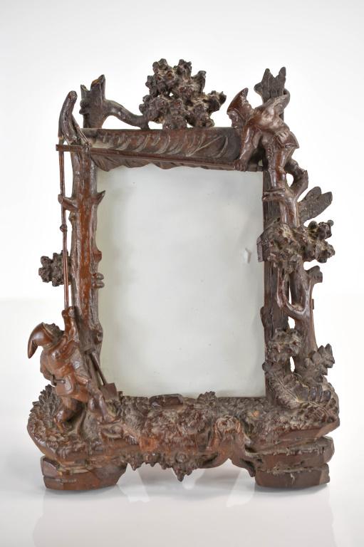 Antique Black Forest Gnome Carved Wooden Frame: An antique Black Forest gnome carved wooden frame, possibly Linder, circa 1880, in fair condition (the frame stand is separated and a wooden piece has become detached). Measures approx. 11.5"l x 8"w