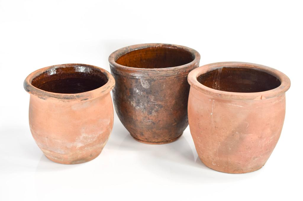 Early Redware Pot Grouping: Includes (3) coiled redware pots with ceramic glazed interiors. Pots have wear commensurate with age and their conditions is as seen in photos. Largest measures approx. 8.5"h Provenance: From a Philad