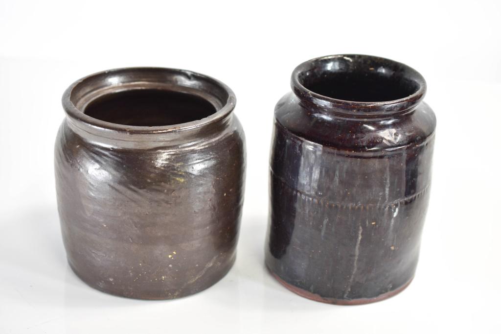 Early Redware Jug Grouping: Grouping includes (2) coiled ceramic glazed redware containers. (1) container has a pattern of smalled raised bumps circling around exterior. Largest measures approx. 6"h Provenance: From a Philadelph