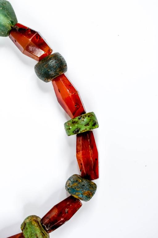 Vintage Carnelian Agate Bicone Bead Necklace: Vintage bicone faceted carnelian agate beads strand necklace with green and red stone beads. Beads are in a range of sizes. Necklace is 29" in length. Weight: 220 grams. Attributable to Idar Oberstein