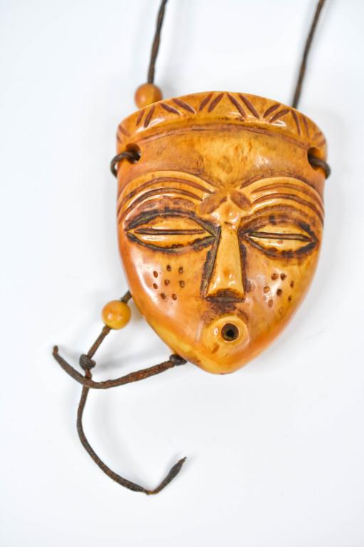 Antique African Hand Carved Cow Bone Pendant: Measures 2" wide x 2 1/2" in height.