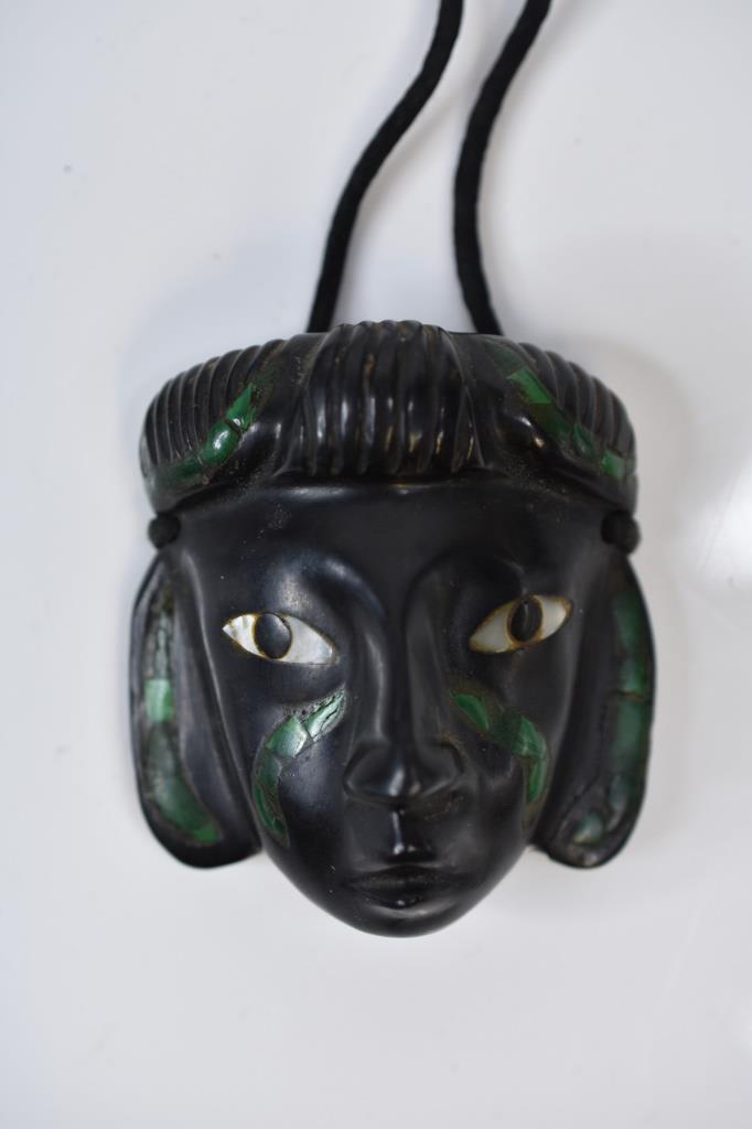 Black Stone Malachite Mayan Aztec Mask Pendant: Black stone malachite and mother of pearl inlay Mayan, Aztec tribal mask pendant. Measure 2 1/2" x 2 1/2".From a single owner collection. Estate was passed down to consignor.