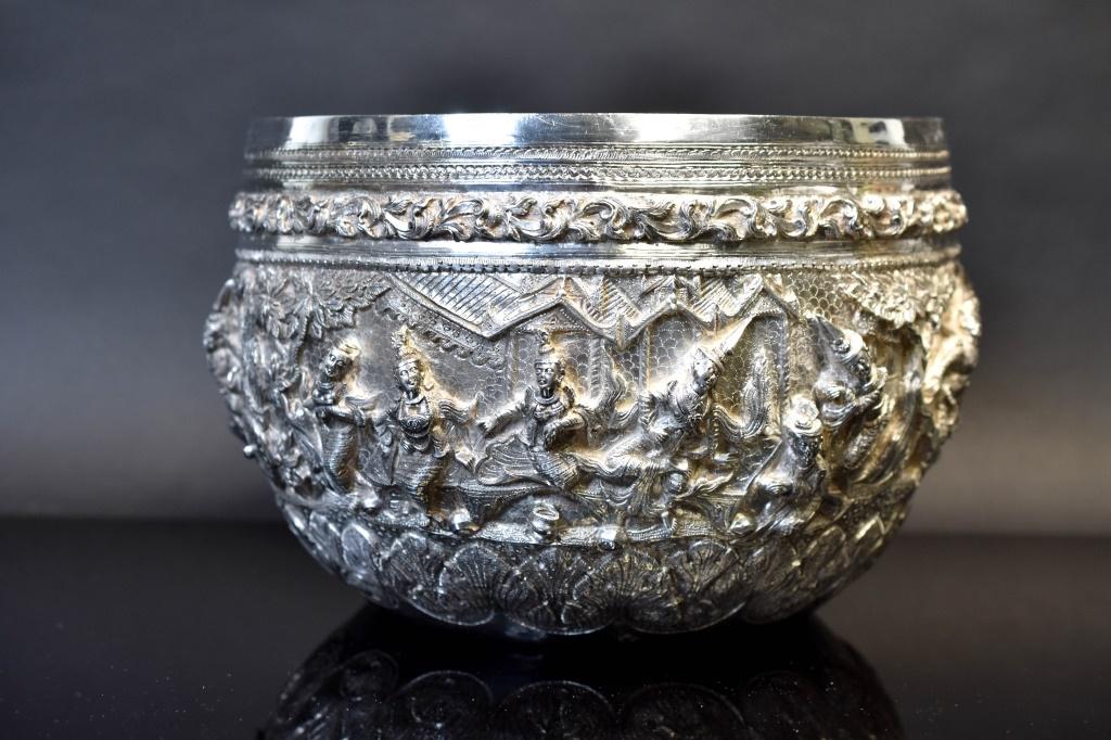 Impressive Burmese Repousse Silver Centerpiece: Includes a large and most impressive Thai st silver centerpiece bowl having an intricate repousse design through the exterior Depicting Traditional Scenes And Showing Detailed Figures Against A Chisel