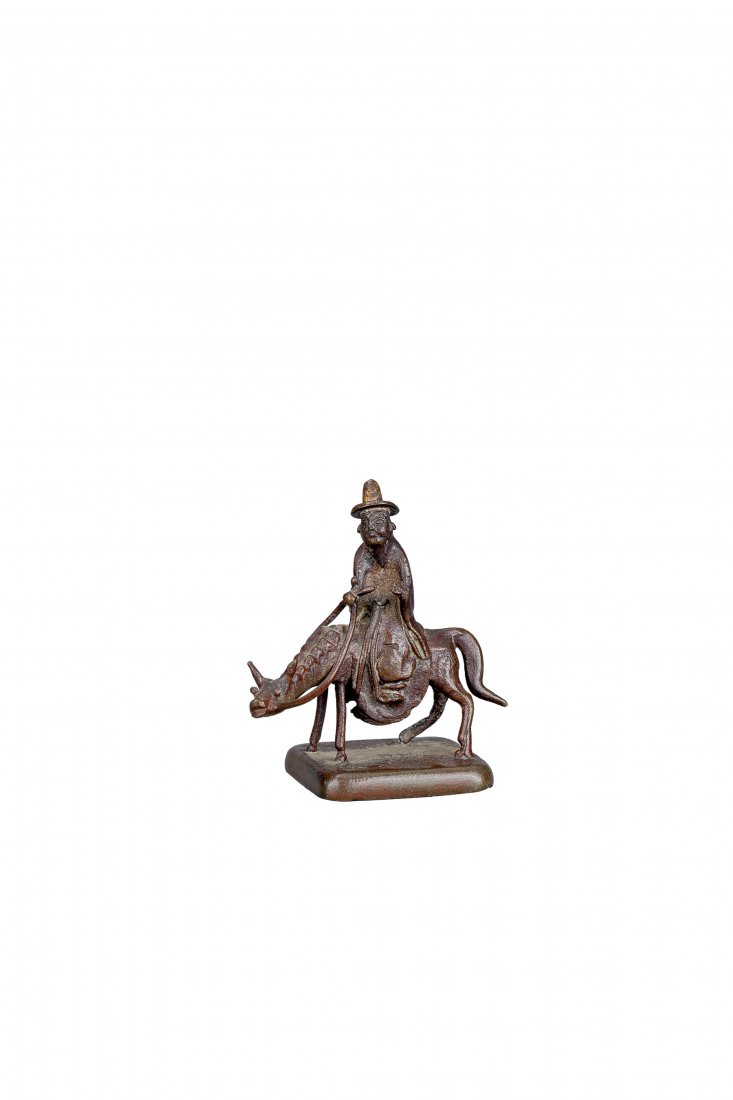 A BRONZE SEAL , MING DYNASTY: A SMALL BRONZE 'A SCHOLAR-OFFICIAL RIDING A DONKEY' SEAL , MING DYNASTY明 銅雕高士騎驢印章