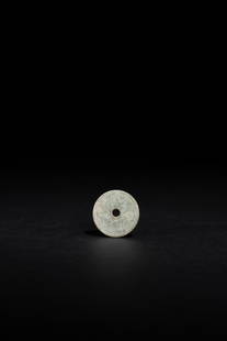A SMALL AND CELADON JADE DISC, WESTERN ZHOU DYNASTY: A SMALL AND CELADON JADE DISC, WESTERN ZHOU DYNASTY西周 鳥紋玉系璧D. 2.6 cm