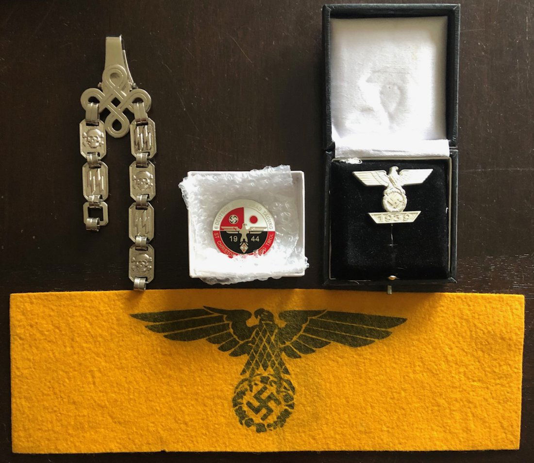WWII GERMAN NAZI MILITARY GROUPING: LOT 4 ITEMS... YELLOW AND BLACK FELT STATE SERVICE ARMBAND, 1939 PIN W/ EAGLE OVER SWASTIKA IN WREATH OVER 1939, 1944 RED WHITE AND BLACK ENAMELED PIN, AND A METAL BELT STRAP?