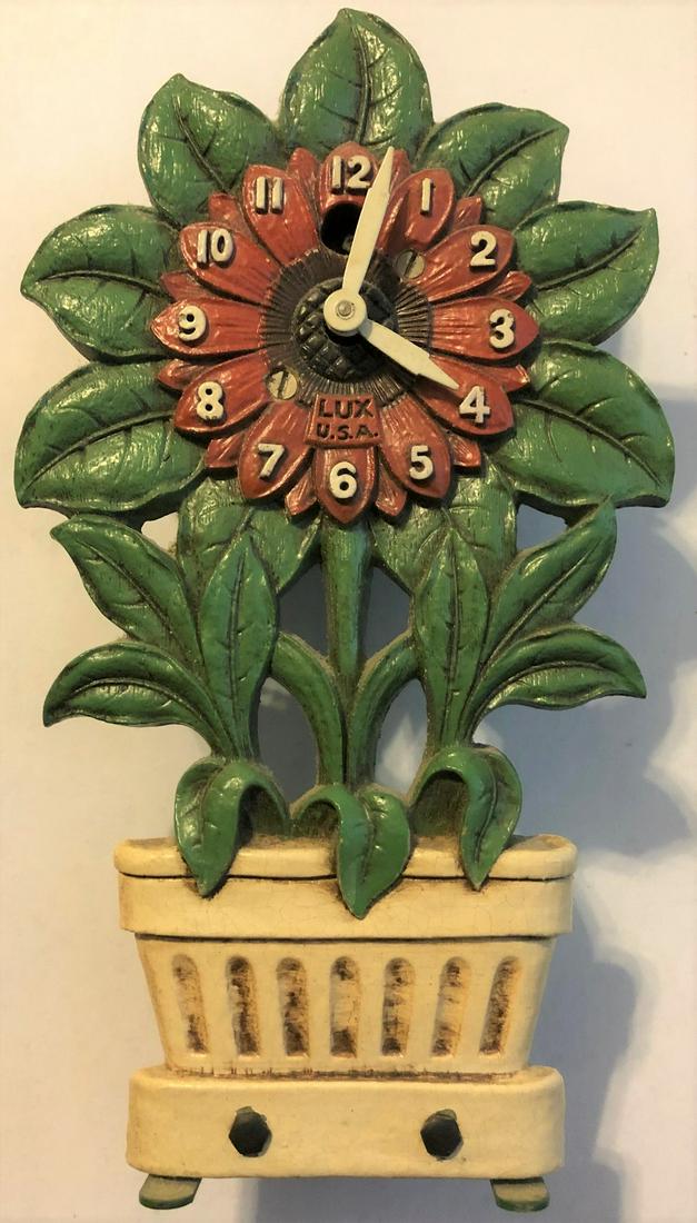 LUX SUNFLOWER IN POT PENDULETTE CLOCK: LUX SUNFLOWER W/ RED CENTER IN WHITE POT PENDULETTE WALL CLOCK - NO. 329 CIRCA 1940 - 3 3/4" WIDE X 6 1/2" HIGH