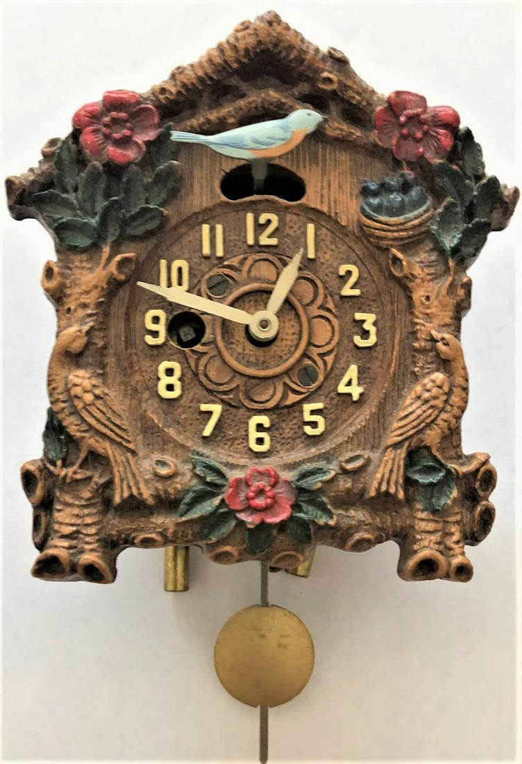 ANIMATED BLUE BIRD & NEST PENDULETTE WALL CLOCK: ANIMATED BLUE BIRD FEEDING NEST OF BABY BIRDS W/ 3 RED FLOWERS AND BIRD ON EACH SIDE - PENDULETTE WALL CLOCK - NO. 370 - CIRCA 1935 - 4" X 6"