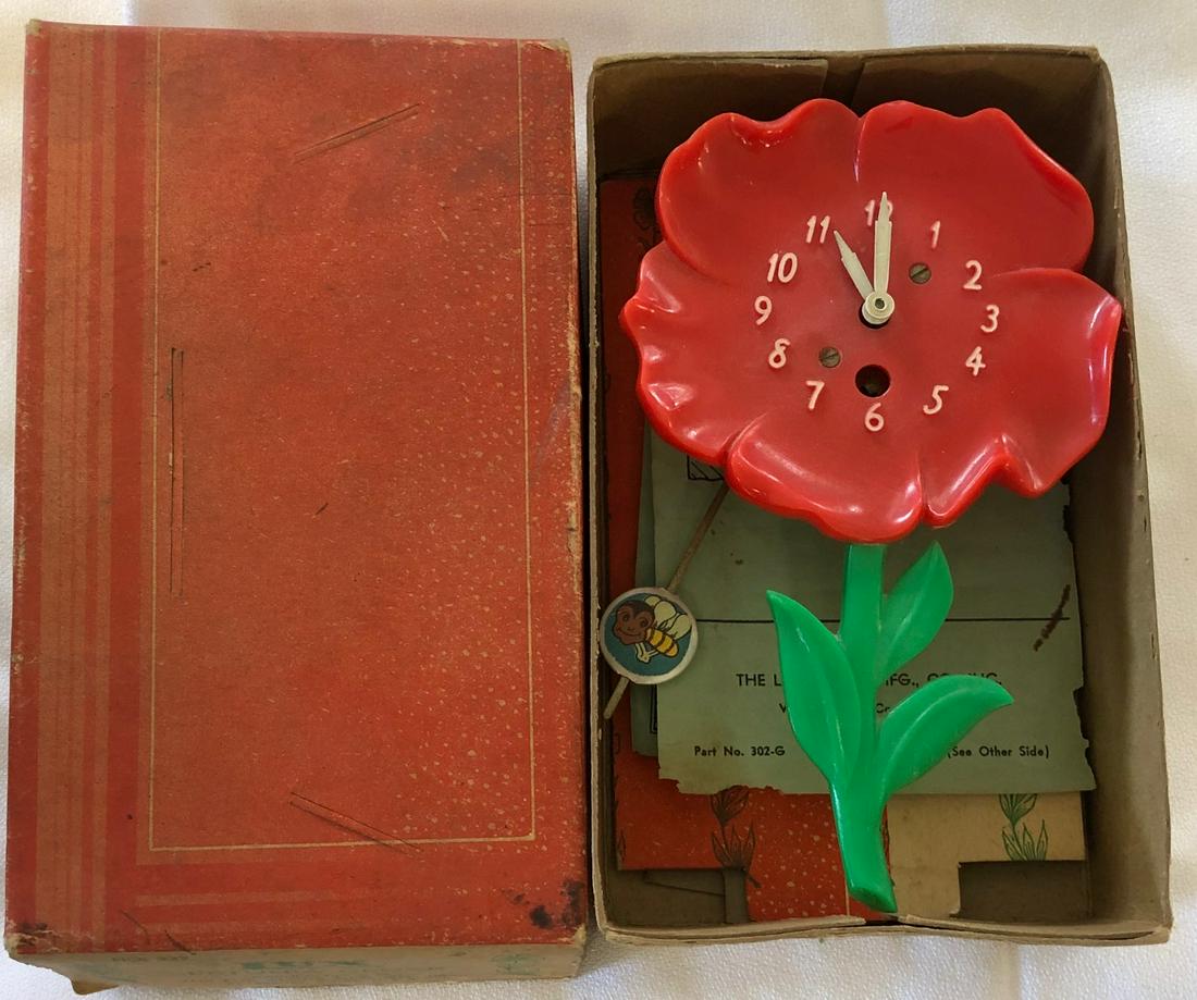 LUX RED 'FIRE CHIEF PETUNIA' PENDULETTE WALL CLOCK: LUX RED 'FIRE CHIEF PETUNIA' PENDULETTE WALL CLOCK WITH BUMBLE BEE PENDULUM - NO. 322 CIRCA 1951 - 4" X 6 1/2"