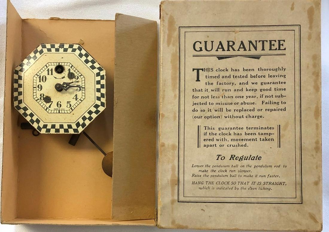KEEBLER OCTAGONAL CHECKERED PENDULETTE CLOCK: KEEBLER CLOCK CO. IVORY, BLACK AND WHITE CHECKERED BORDER PENDULETTE WALL CLOCK - NO. 210 CIRCA 1930 - 2 3/4" X 5 1/2"