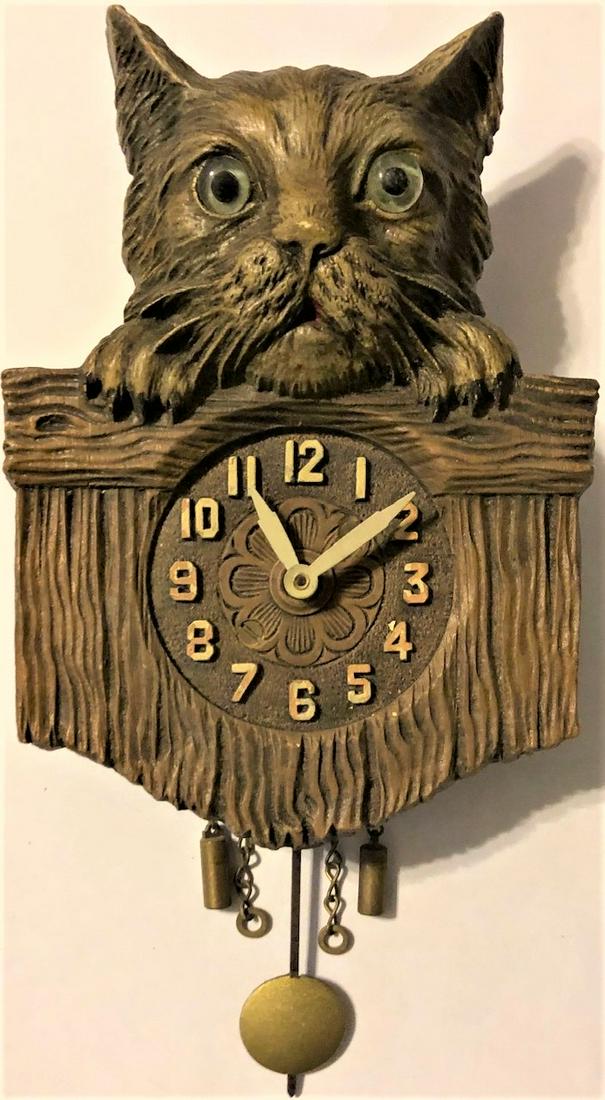 LUX BROWN KITTY CAT PENDULETTE WALL CLOCK: LUX BROWN KITTY CAT W/ GLASS EYES, PEEKING OVER FENCE PENDULETTE WALL CLOCK - NO. 335 CIRCA 1931 - 3 3/4" X 7"