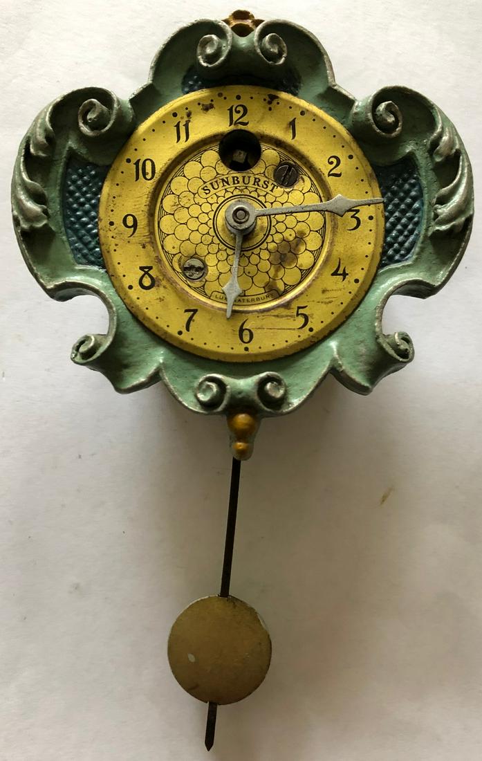 LUX SCROLLED SUNFLOWER PENDULETTE WALL CLOCK: CIRCA 1930 - 35, 6" HIGH X 3 3/8" WIDE - THE LUX CLOCK MFG. CO. WATERBURY CONN. U.S.A.