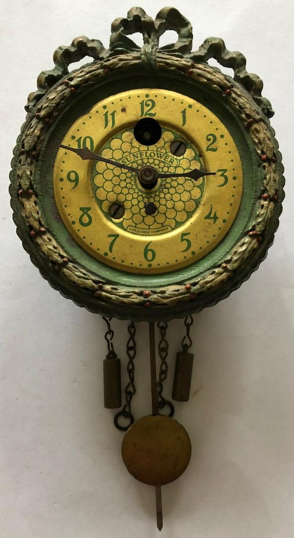 LUX CHRISTMAS WREATH PENDULETTE WALL CLOCK: CIRCA 1930 - 1935, 6" HIGH X 3" WIDE - THE LUX CLOCK MFG. CO. WATERBURY CONN. U.S.A.