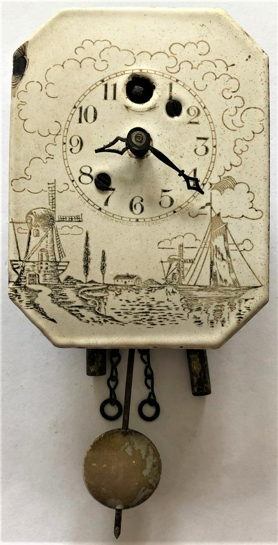LUX PORCELAIN ENAMEL DUTCH SCENE WALL CLOCK: DUTCH SCENE WITH WINDMILLS, BOAT, ETC. - CIRCA 1930 - 5 3/4" HIGH X 3 3/4" WIDE - THE LUX CLOCK MFG. CO. WATERBURY CONN. U.S.A. - CHIP TO PORCELAIN DIAL