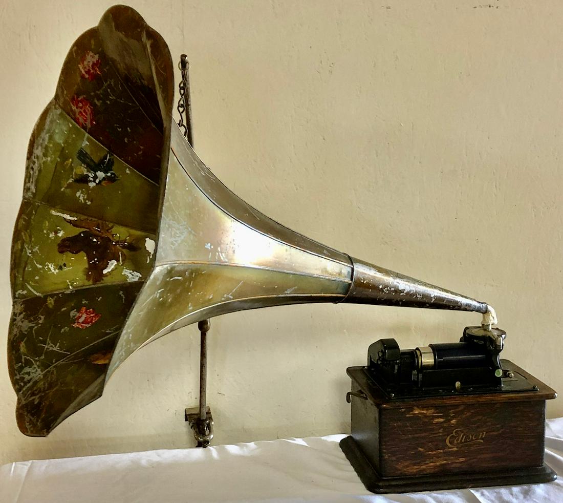 OAK CASED EDISON PHONOGRAPH W/ LG. HORN & 38 RECORDS: EDISON PHONOGRAPH WITH HAND PAINTED 30" HORN / 22" DIAMETER - TOGETHER WITH 38 CYLINDER 'RECORDS'â€¦MOST IN ORIGINAL CONTAINERS - HORN BRACKET / HANGER INTACT - MACHINE WORKS BUT END OF HORN NEEDS