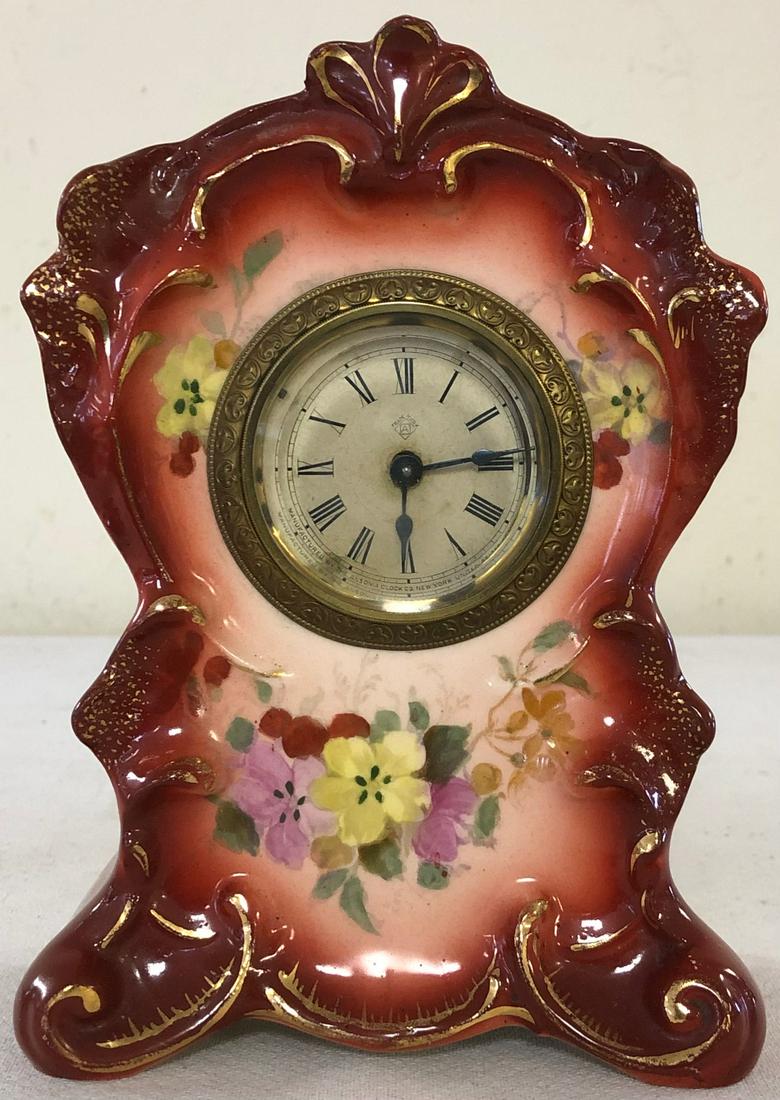 MINIATURE GERMAN ROYAL BONN PORCELAIN SHELF CLOCK: GERMAN "ASTER" PATTERN ROYAL BONN CLOCK MARKED ON BACK WITH ROYAL BONN LOGO - ANSONIA BRASS WORKS - IMPRESSED #2644 - RUST / ORANGE WITH GILT HIGHLIGHTS AND FLORAL DECORATION - WORKING WHEN TESTED - N